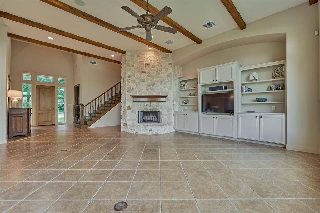 The stone fireplace, mantle and ceiling beams add so much character to this space and give a rustic flare.