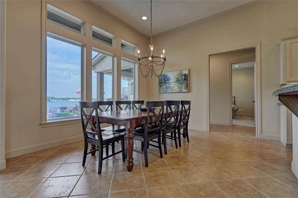 The spacious dining room features elegant lighting and tranquil views of the water.