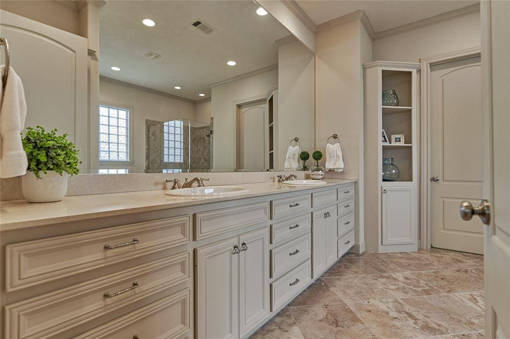 The ensuite has dual vanities and loads of storage.