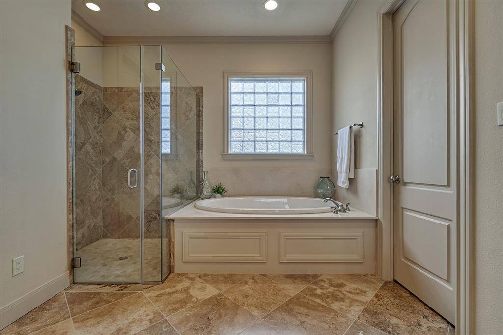 A soaker tub and a walk-in shower for unwinding at the end of a long day.