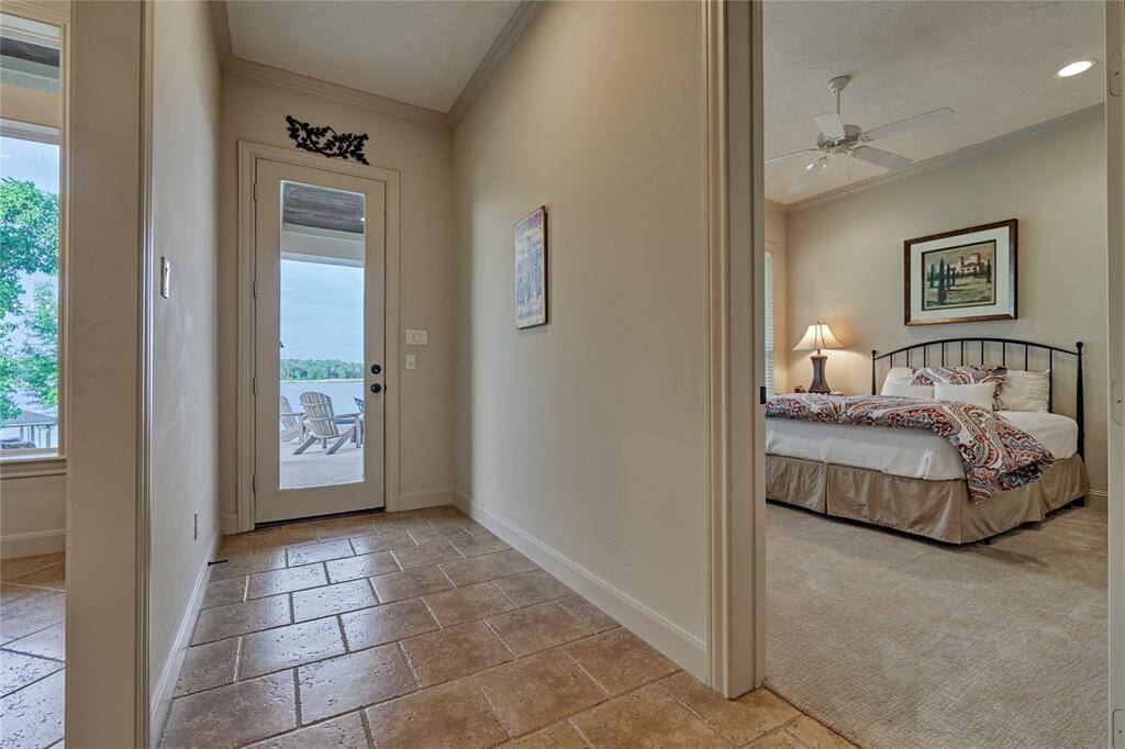 To the right, a first floor guest suite. To the left, a French door that leads to the backyard.