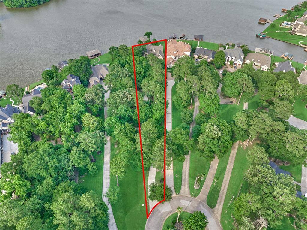 A sprawling 1 acre lot with 118 feet of Lake Conroe's serene shoreline.