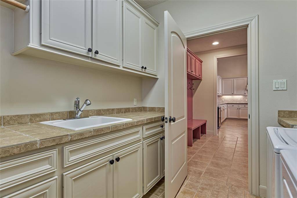 Laundry room with sink is adjacent to the mud room.