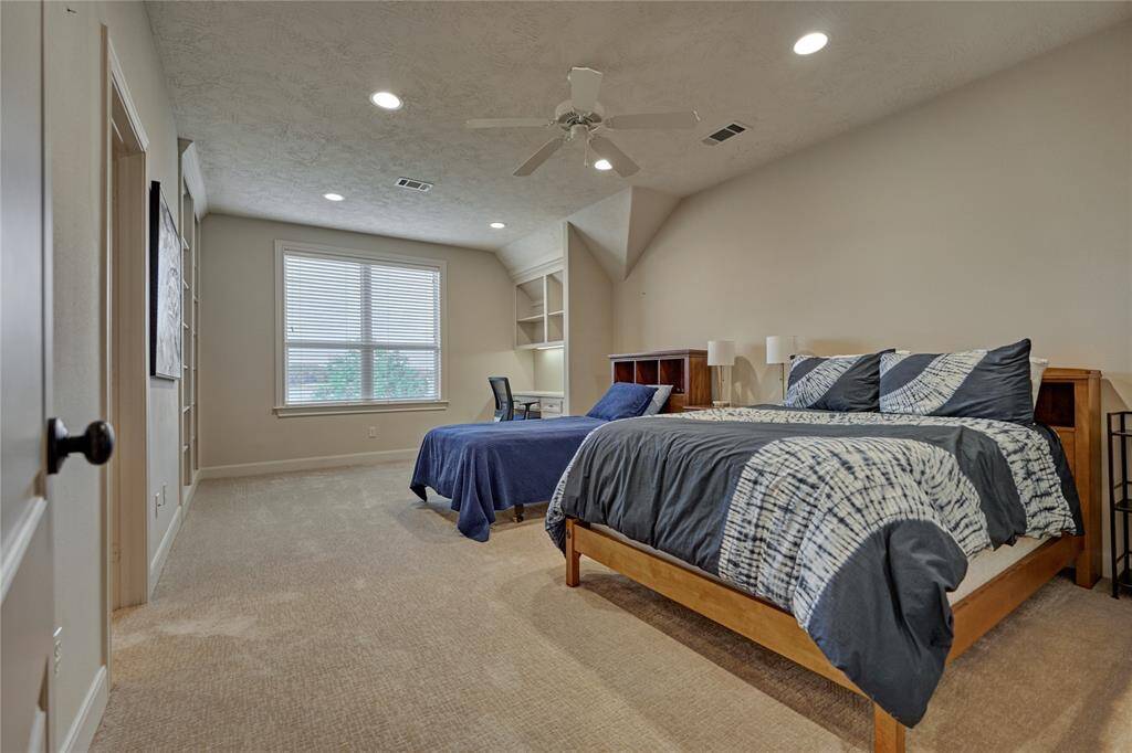 Secondary guest room #1 with plush carpeting and an office nook.
