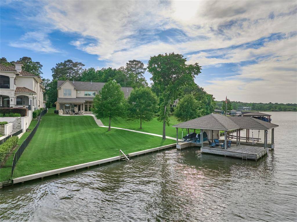 Spectacular boathouse with lifts for all of your water toys and a sitting area to enjoy lake breezes and breathtaking views.