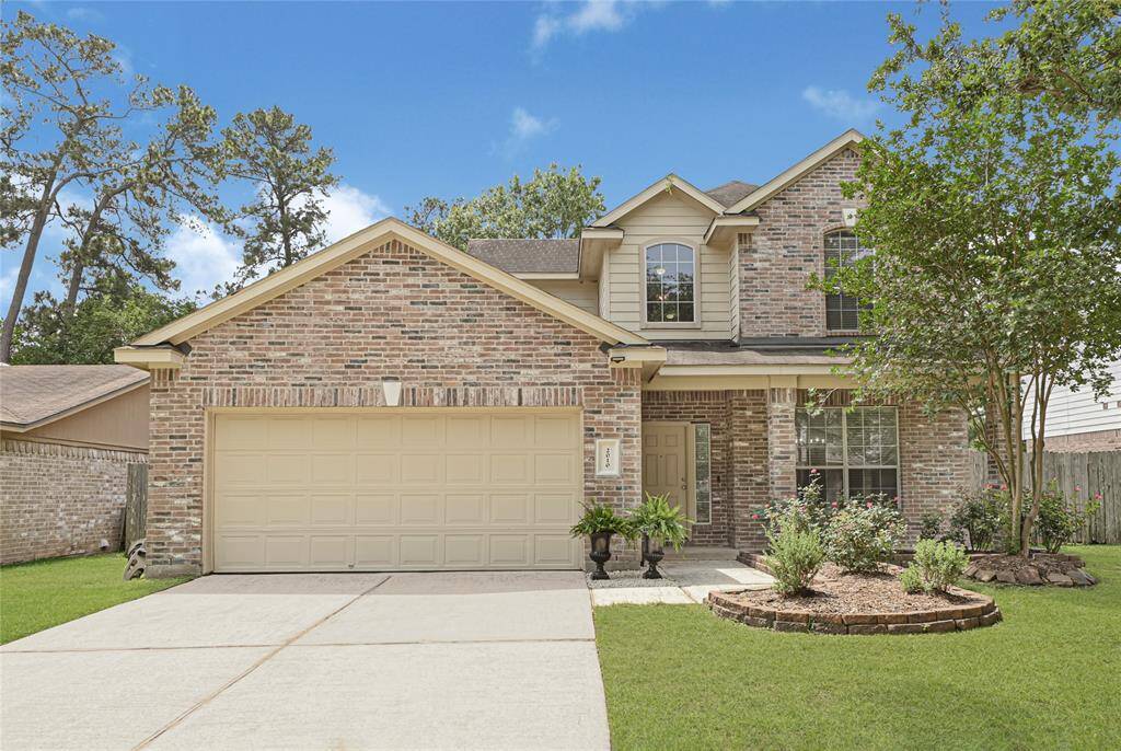 With front yard landscaping and mature trees, this two-story brick home has fantastic curb appeal! *Grass edited*