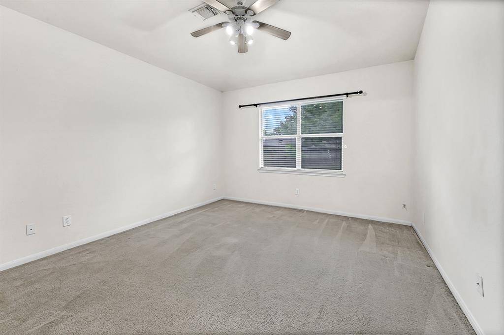The large primary bedroom has a big window overlooking the backyard. The room offers a clean, neutral space ready for you to make it your own!