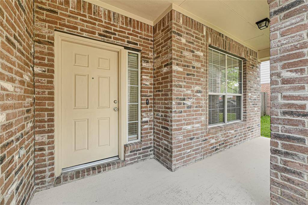 Whether welcoming guests or enjoying your favorite beverage beneath the covered front porch, this inviting entrance to the home is sure to impress!