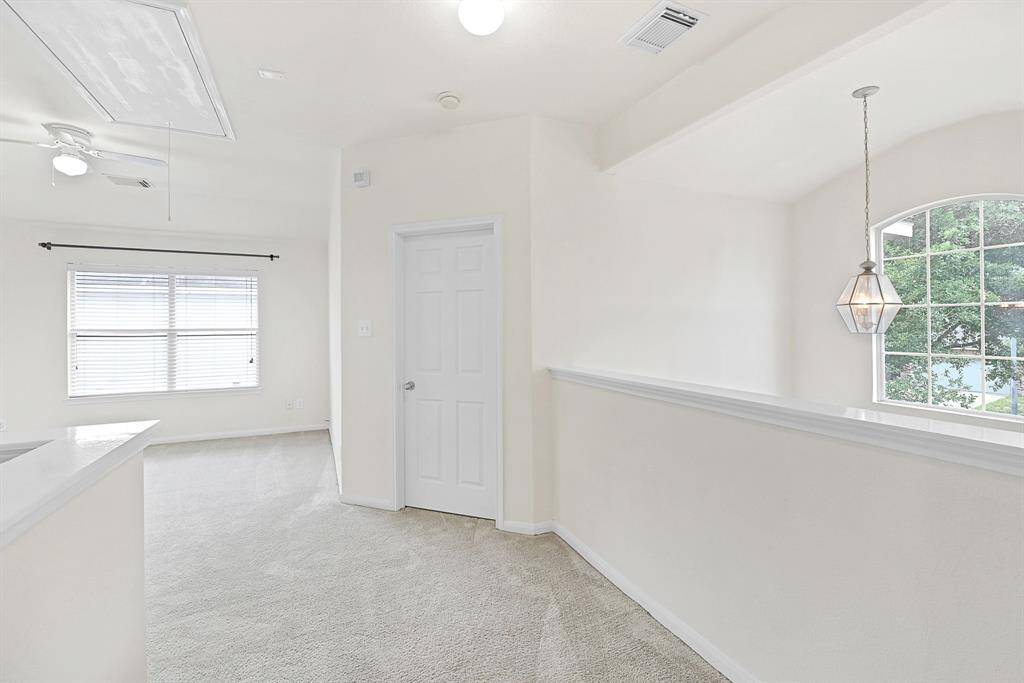 View upon ascending the stairs looking towards the game room and secondary bedroom.