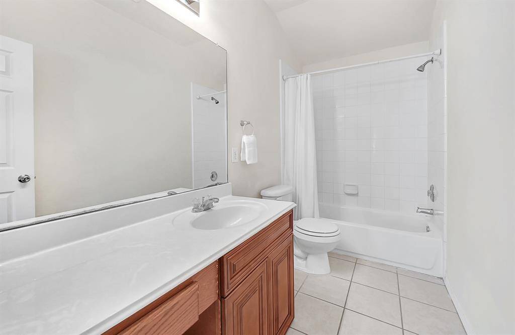 Centrally located secondary bath with vanity area and shower/tub combo.