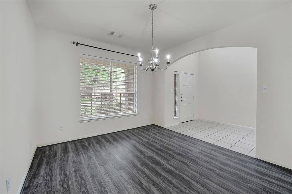 Alternate dining room view looking towards the tiled front door entryway.