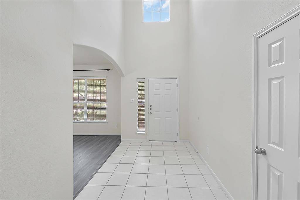 Bright entryway with high ceilings and windows for natural light; such a simple and clean design.