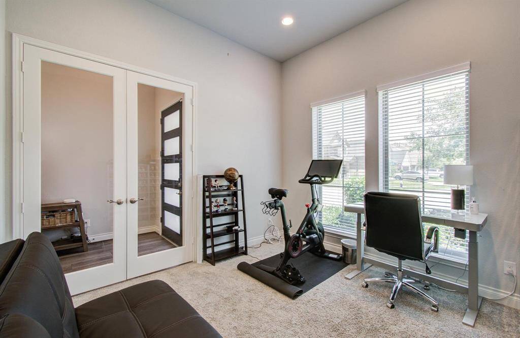 The office is thoughtfully placed near the front door, offering plenty of natural light and beautiful french doors for added privacy—without making the space feel closed off.