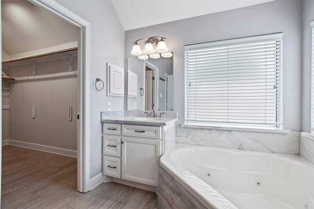 A jetted tub and walk-in closet make this space complete.