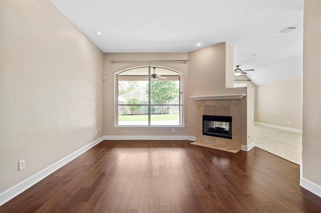 Front living areas a spacious space that share the two sided fireplace with the living area behind it.