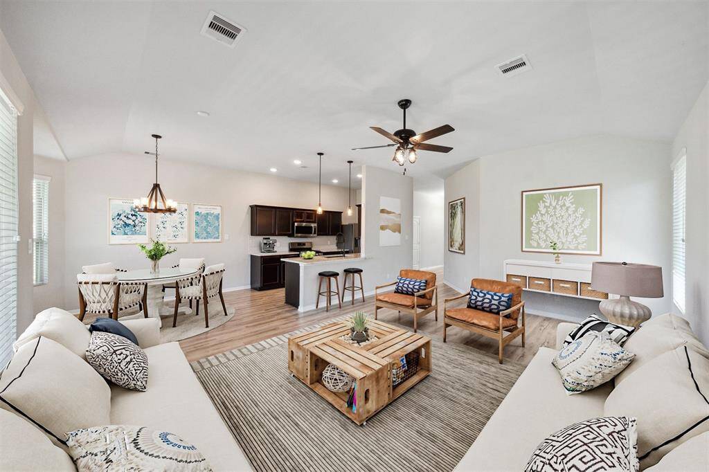Experience the inviting open-concept design of the virtually staged living, dining, and kitchen areas, perfect for modern living and entertaining.