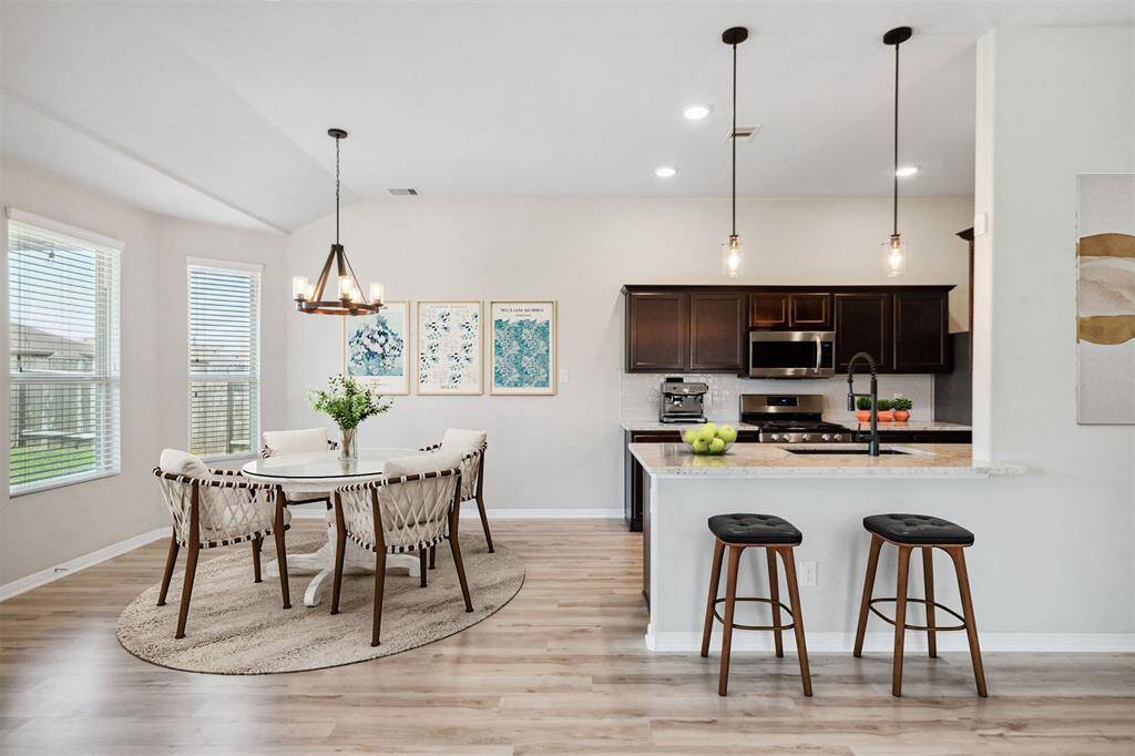 Bright, virtually staged dining area and kitchen.