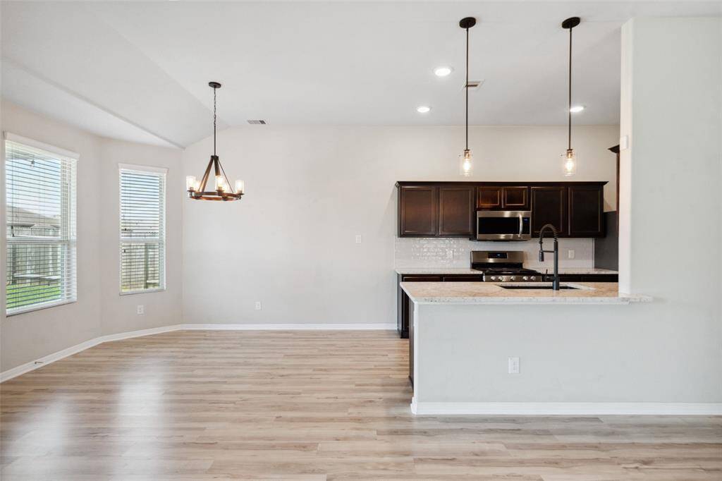 Another view of the dining area and kitchen.