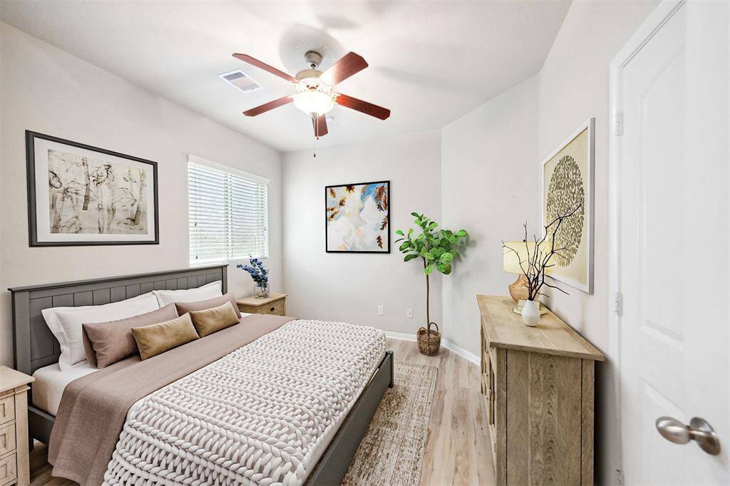 Elegantly bright and airy staged secondary bedroom.