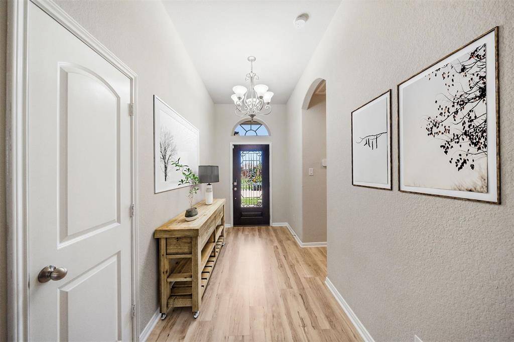 Elegant and illuminated entryway with stylish staging, welcoming you into this spacious and inviting home.
