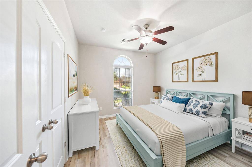 Elegantly bright and airy staged secondary bedroom.