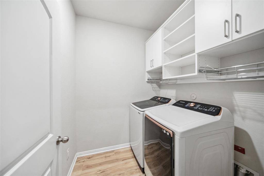 Discover a utility room featuring elegant custom built ins.