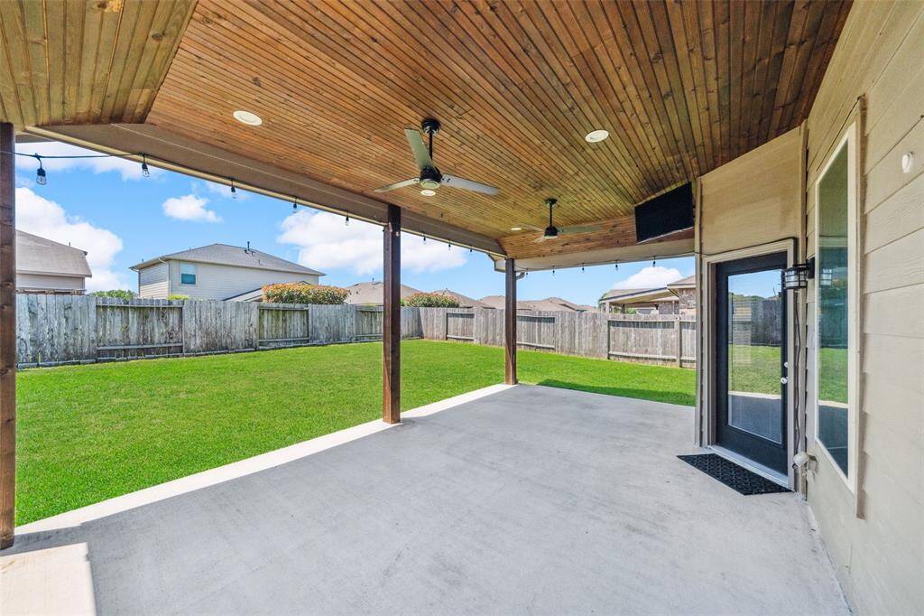 Enjoy the spacious 21' x 13' covered patio, featuring a stained tongue and groove ceiling, dual ceiling fans, and elegant recessed lighting.
