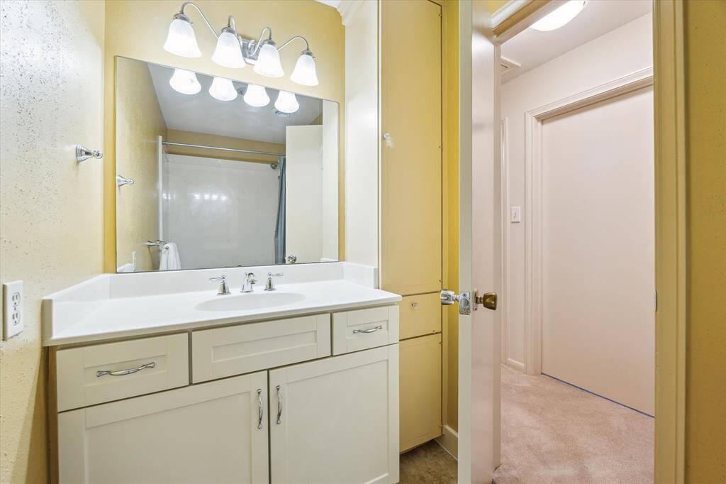 The secondary bathroom upstairs has a vanity area.