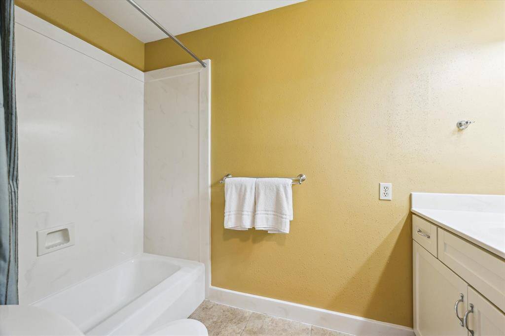 The tub/shower combination in the secondary bathroom is located upstairs.