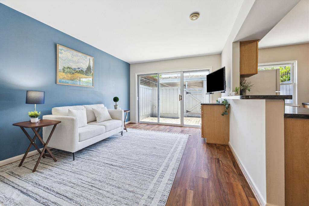 This room is currently being used as a den, but could easily be repurposed into a dining area. The room comes complete with a custom-built-in unit with drawers for storage. This room leads to the paved patio area and garage.