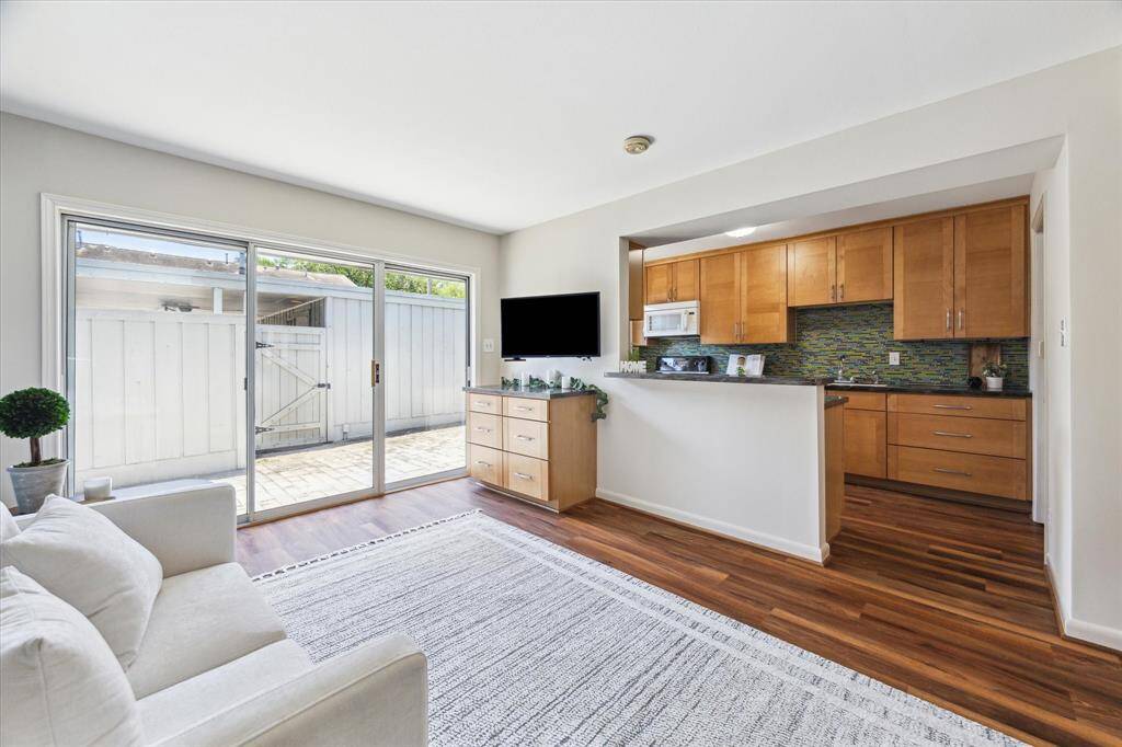 Cabinetry and splashback have been replaced, and the house has been fitted with drawers and cabinets for storage. The sliding glass doors leading to the patio have also been replaced. This ensures flow between rooms, especially from the den to the kitchen.