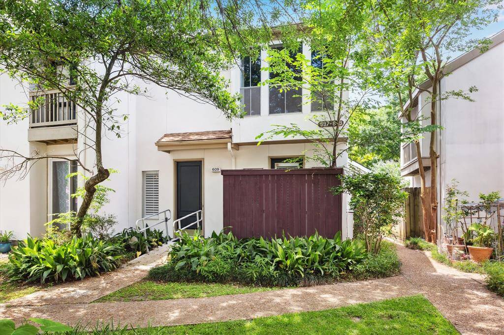 Front of home - Corner unit with lush foliage in front of property.