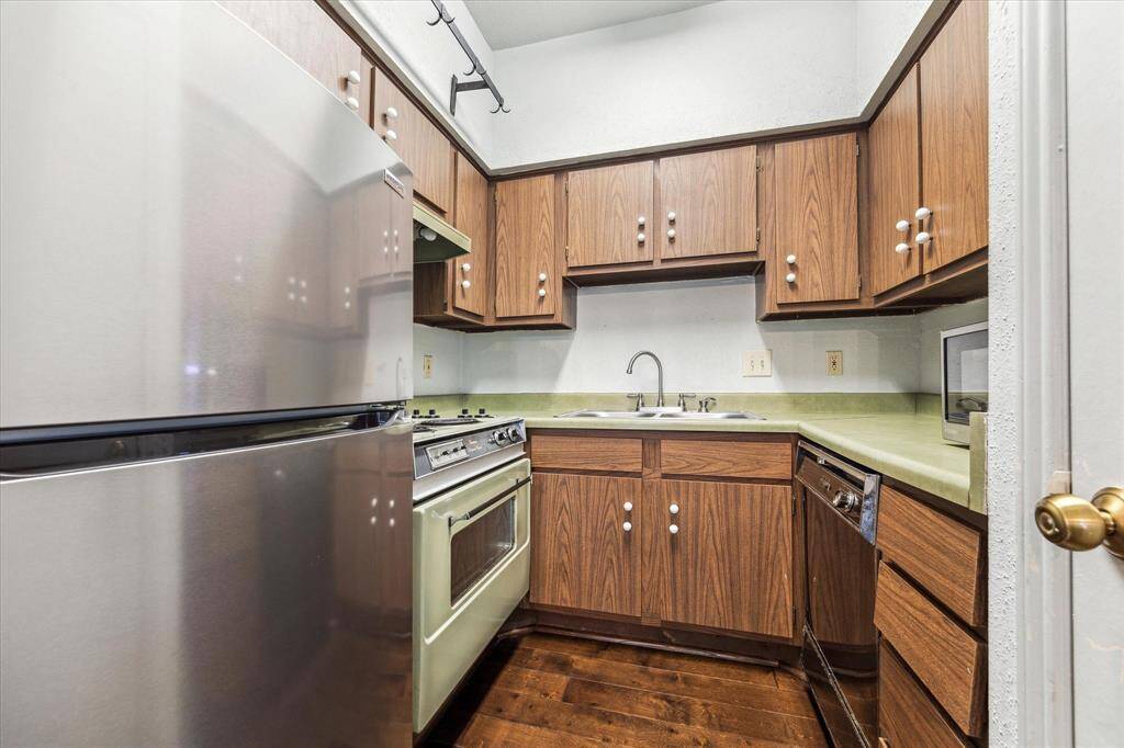 Kitchen - Stainless steel refrigerator, microwave, & updated flooring.