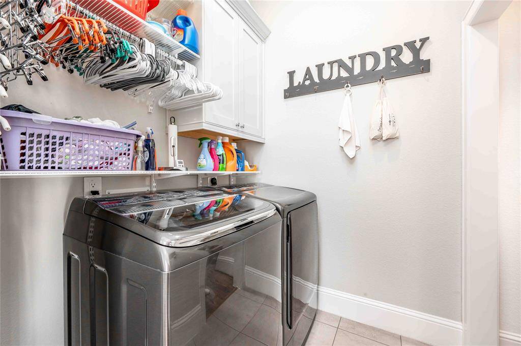 Generous size laundry room with ample storage space.