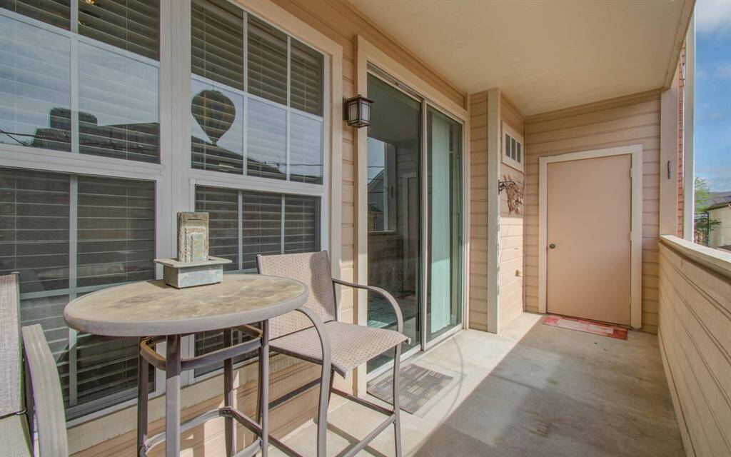 Another view of balcony featuring a storage closet great for outdoor storage.