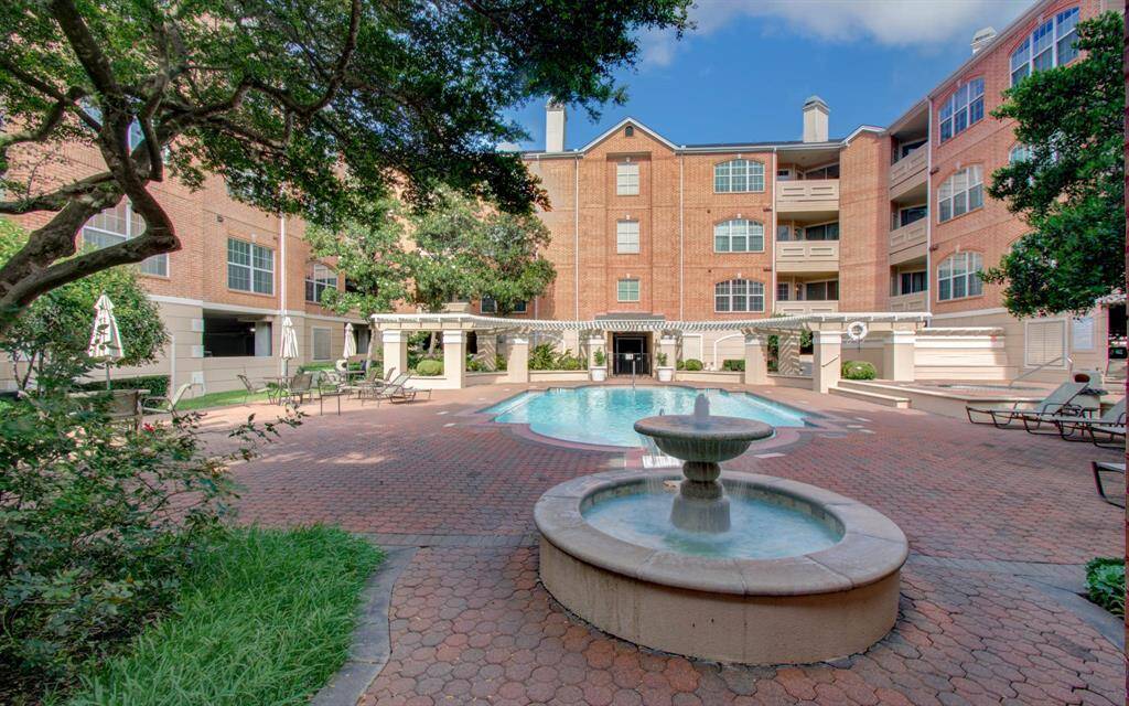 Courtyard featuring a central swimming pool and hot tub with ample seating, creating an inviting atmosphere for relaxation with family and friends