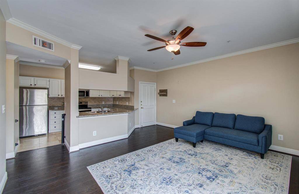 Open-plan living space with neutral color palette and wood flooring.