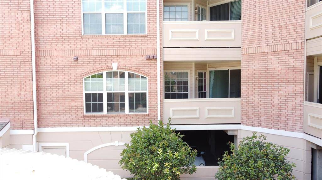 This photo shows a brick apartment building with a traditional design. It features large windows and balconies, and there's greenery in front, adding to the charm. The structure appears well-maintained, suggesting a comfortable and appealing living space.
