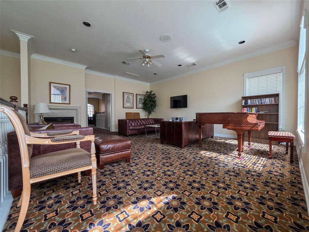 Charming clubhouse featuring a cozy seating area, elegant piano, and ample natural light—perfect for relaxing or entertaining.