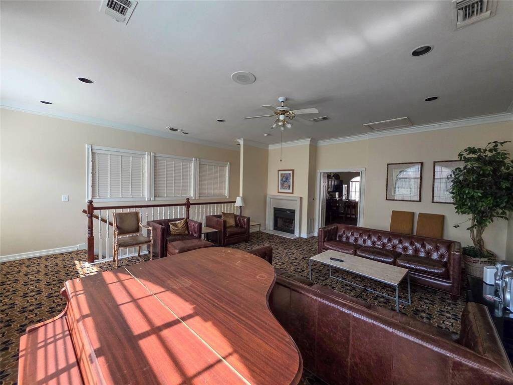 Elegant clubhouse with cozy seating, a grand piano, and a warm fireplace—perfect for relaxation and entertaining.