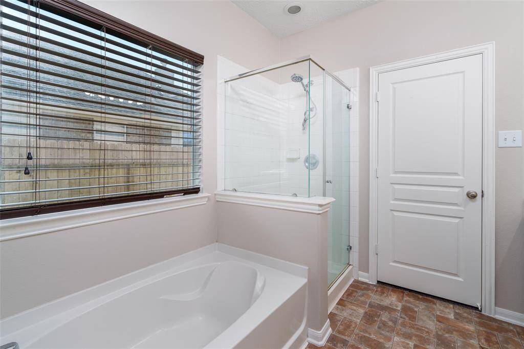Master bathroom features a beautiful shower and a separate tub, offering the perfect space for relaxation.