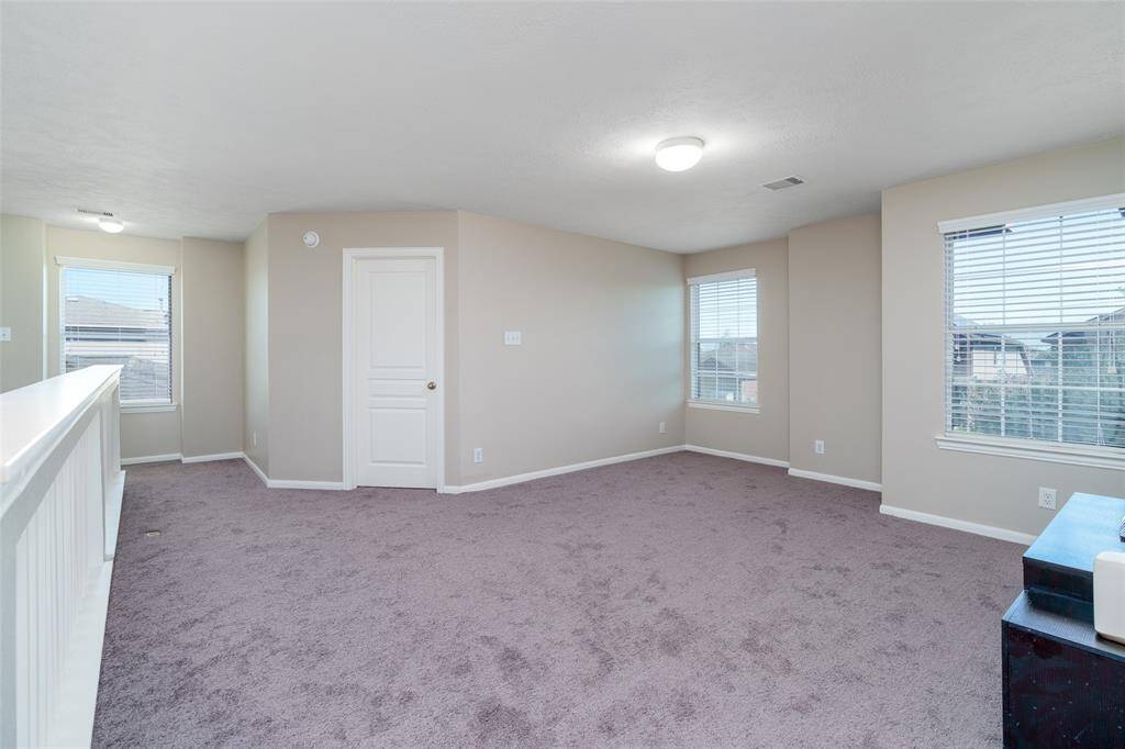 Game room with an overlook of the living room, ideal for relaxation or activities.