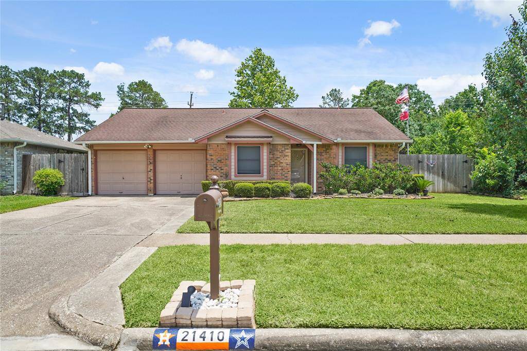 Charming single-story brick home with a two-car garage and well-maintained front yard. Features a covered entrance with mature shrubs and a neatly trimmed lawn, and solar screens.