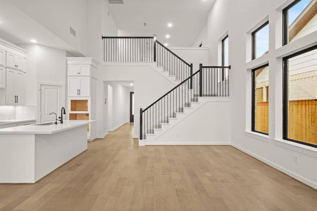 This staircase is wide open to the upstairs gameroom. Along the stairs, a subtle window adds character to this space.