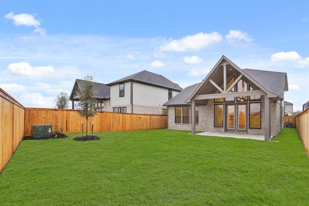 Relax on this dreamy, oversized, covered patio with a gas line for a grill.