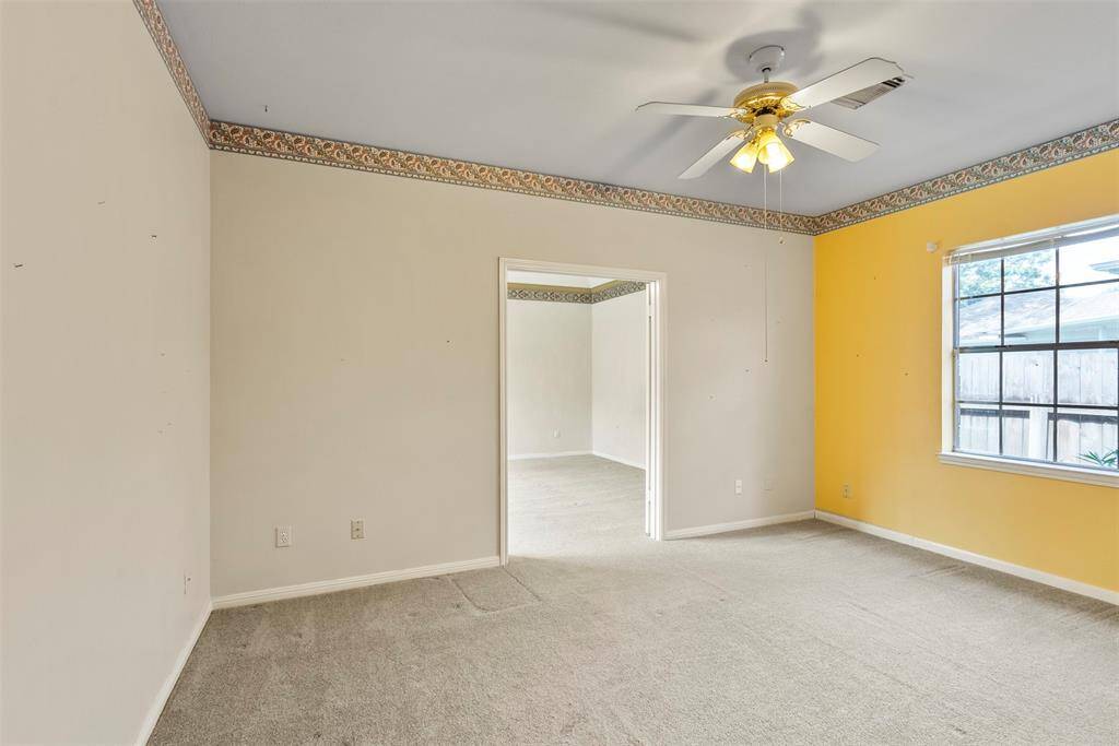 This 4th bedroom off the primary suite is perfect for a home office or parents retreat!