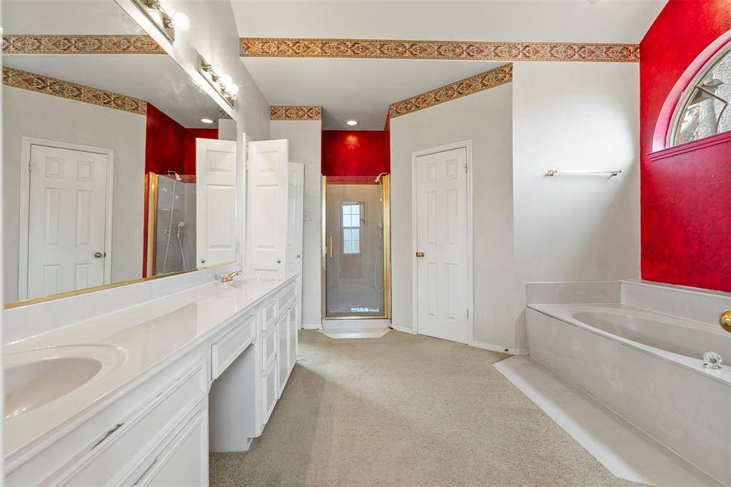 Soaking tub, dual sinks, vanity area and separate shower makes this primary bath have all the bells and whistles!