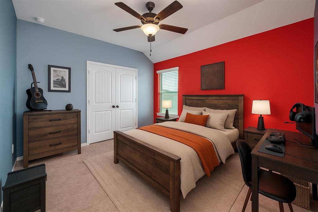 This charming bedroom showcases custom designer paint, plush carpeting, and a ceiling fan to keep the space cool and comfortable year-round.