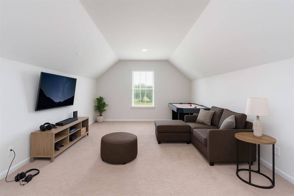Enjoy movie nights in the cozy media room, complete with plush carpet, recessed lighting for the perfect ambiance, and a window that fills the space with natural light.