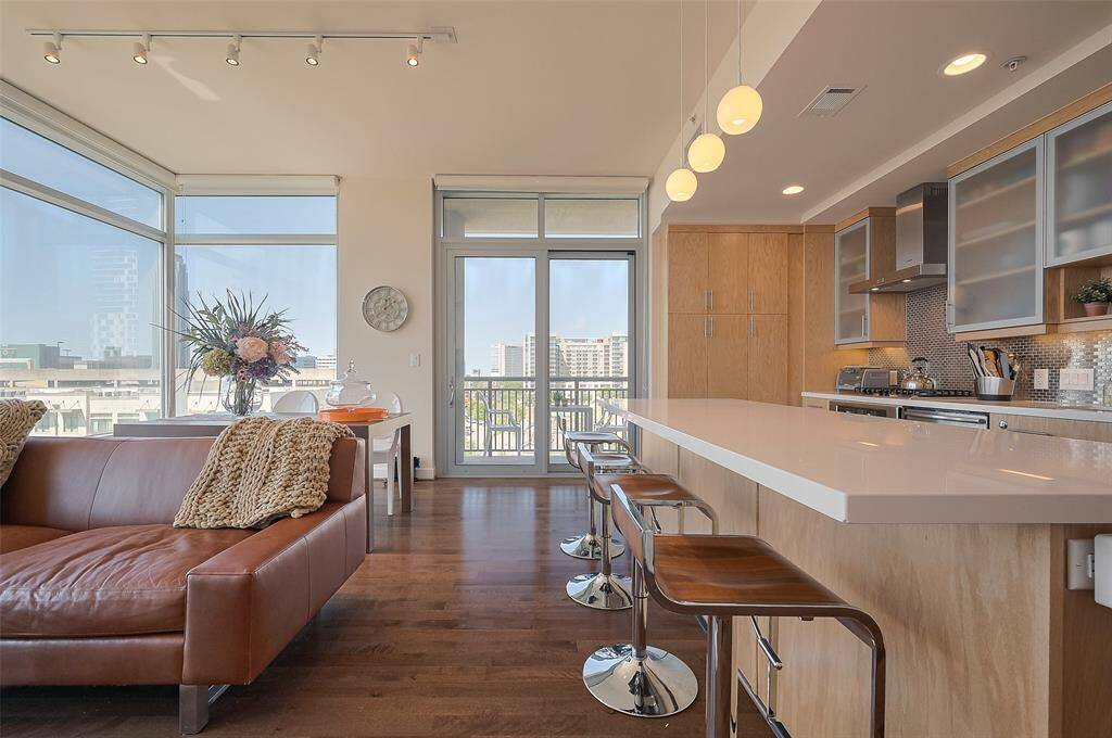 Another view of the kitchen to living room with floor to ceiling views.